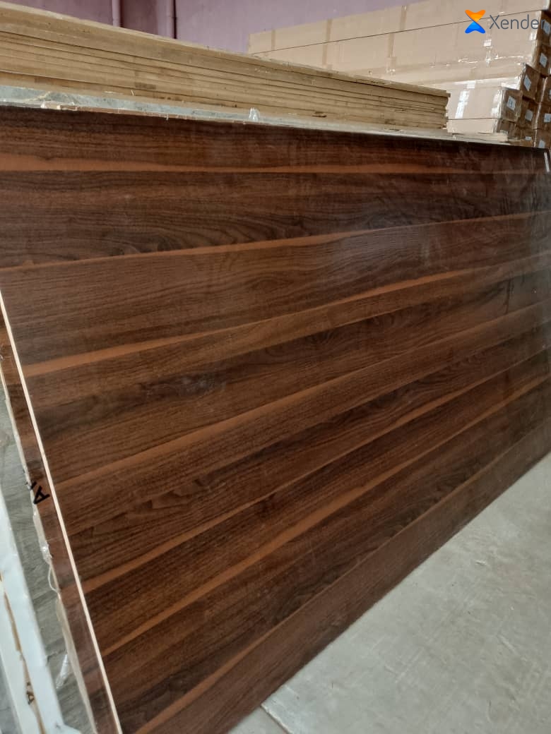 Stack of dark walnut finish wall panels ready for delivery